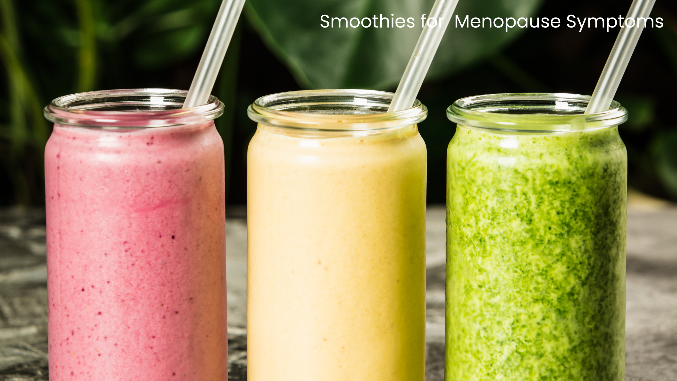 three glass jars containing smoothies, one is pink, one is yellow and one is green. All have a straw
