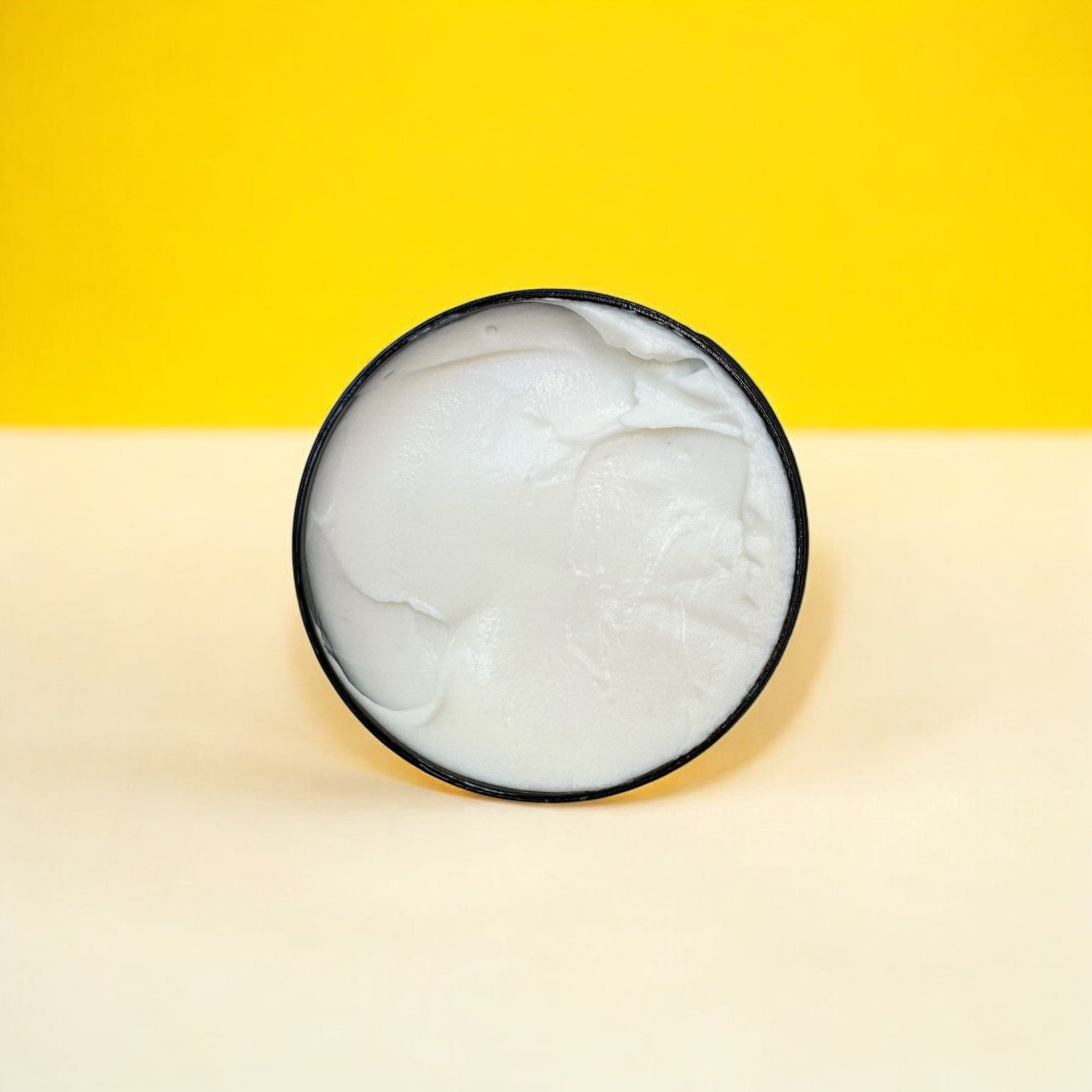 Open container of creamy white Lemongrass Hand Cream showcasing natural skincare with botanical ingredients and sustainable. - Lemongrass Hand Cream - PUREMESS SKINCARE