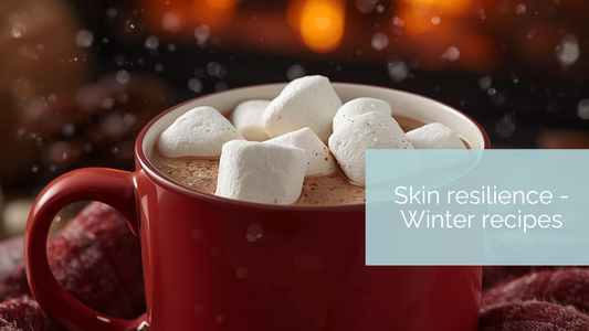 Cozy winter scene with a mug of chilli hot chocolate topped with marshmallows, next to Puremess botanical skincare, representing winter skin resilience rituals.