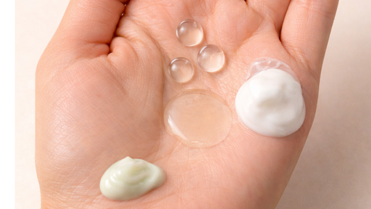woman's palm with different skincare products on it